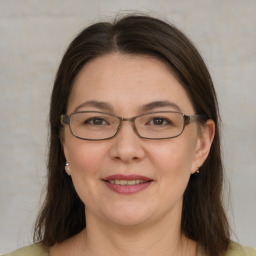 Joyful white adult female with medium  brown hair and grey eyes