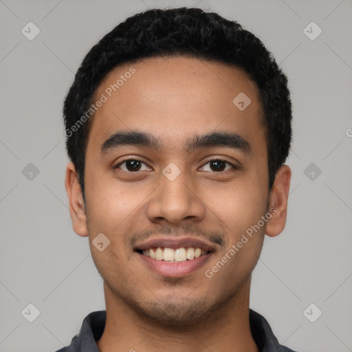 Joyful latino young-adult male with short  black hair and brown eyes