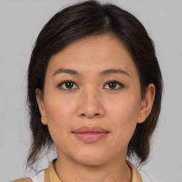 Joyful asian young-adult female with medium  brown hair and brown eyes