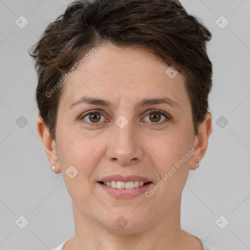 Joyful white adult female with short  brown hair and brown eyes