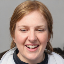 Joyful white adult female with medium  brown hair and blue eyes