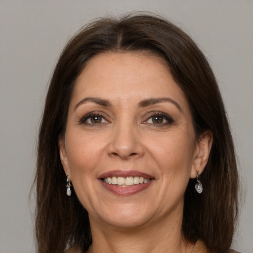 Joyful white adult female with long  brown hair and grey eyes