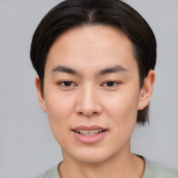 Joyful asian young-adult male with short  brown hair and brown eyes