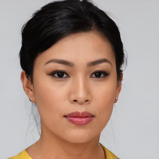 Joyful asian young-adult female with medium  black hair and brown eyes