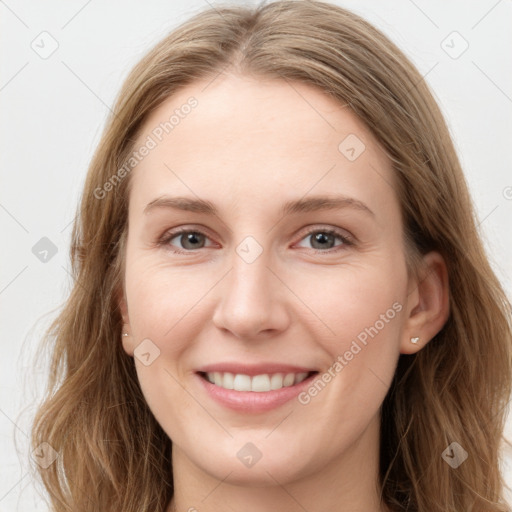 Joyful white young-adult female with long  brown hair and grey eyes