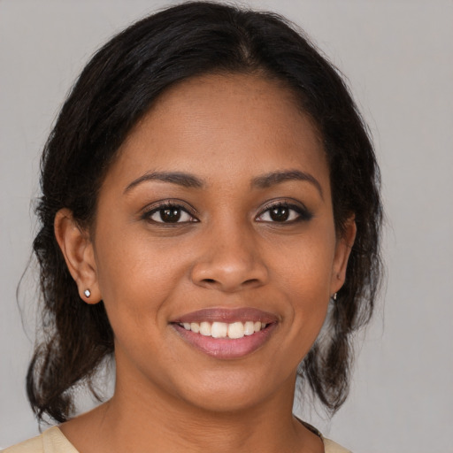 Joyful black young-adult female with medium  brown hair and brown eyes