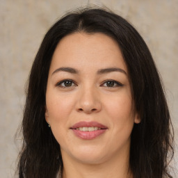 Joyful latino young-adult female with long  brown hair and brown eyes