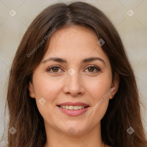 Joyful white adult female with long  brown hair and brown eyes