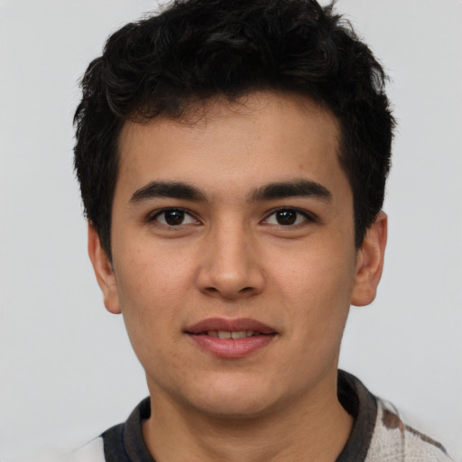 Joyful latino young-adult male with short  black hair and brown eyes