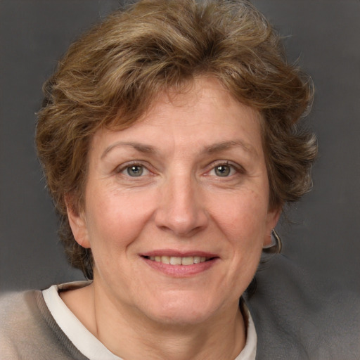 Joyful white adult female with short  brown hair and grey eyes