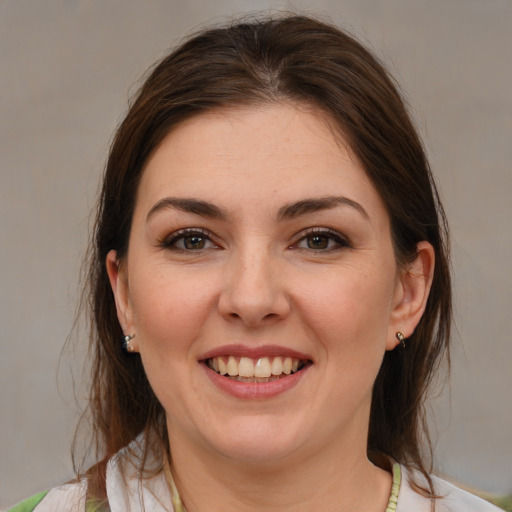 Joyful white young-adult female with medium  brown hair and brown eyes