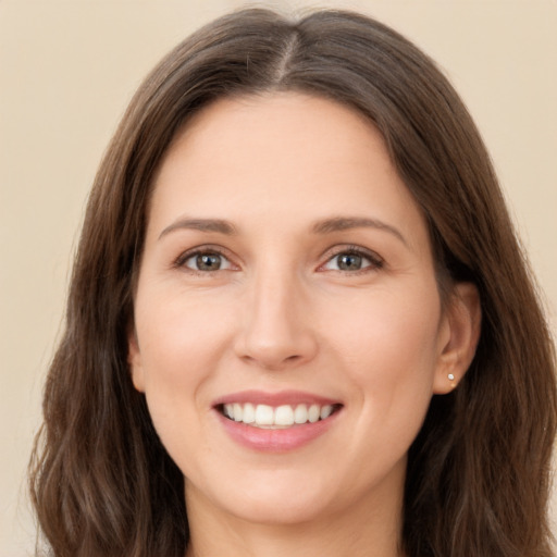 Joyful white young-adult female with long  brown hair and brown eyes