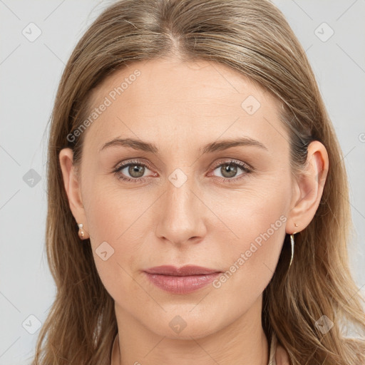 Joyful white young-adult female with long  brown hair and blue eyes