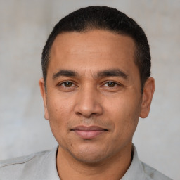 Joyful white adult male with short  black hair and brown eyes