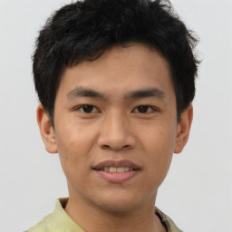 Joyful asian young-adult male with short  brown hair and brown eyes