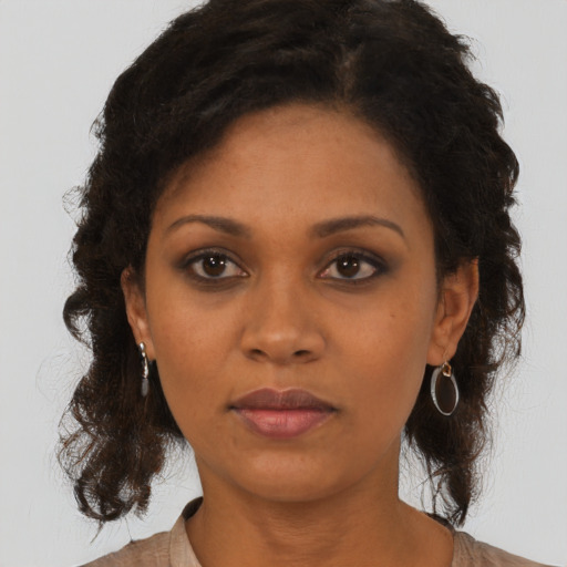 Neutral black young-adult female with medium  brown hair and brown eyes