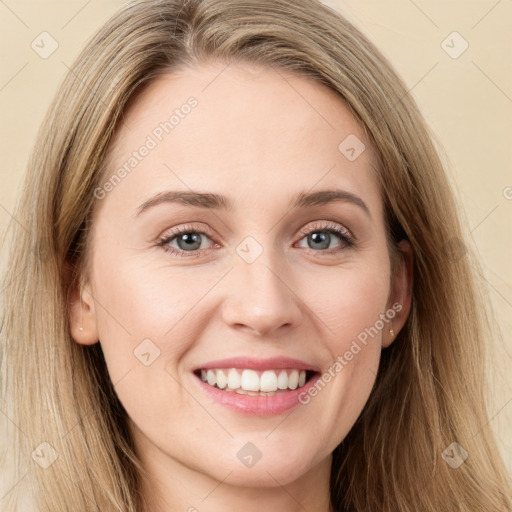 Joyful white young-adult female with long  brown hair and blue eyes