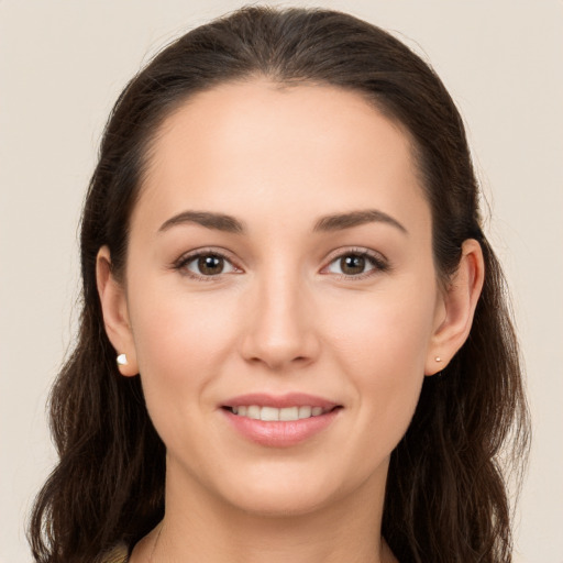 Joyful white young-adult female with long  brown hair and brown eyes