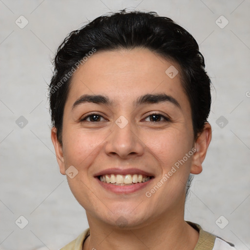 Joyful white young-adult female with short  black hair and brown eyes