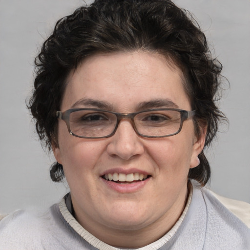 Joyful white adult female with short  brown hair and blue eyes