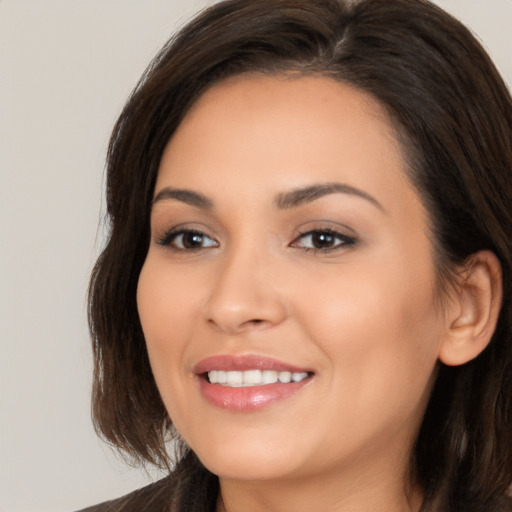 Joyful white young-adult female with medium  brown hair and brown eyes