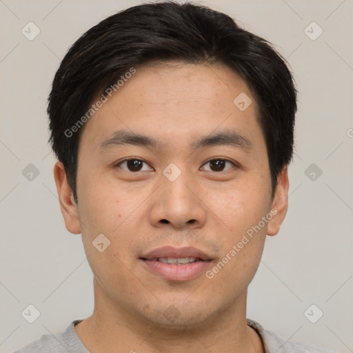 Joyful asian young-adult male with short  black hair and brown eyes