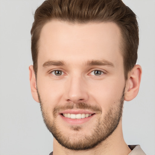 Joyful white young-adult male with short  brown hair and brown eyes