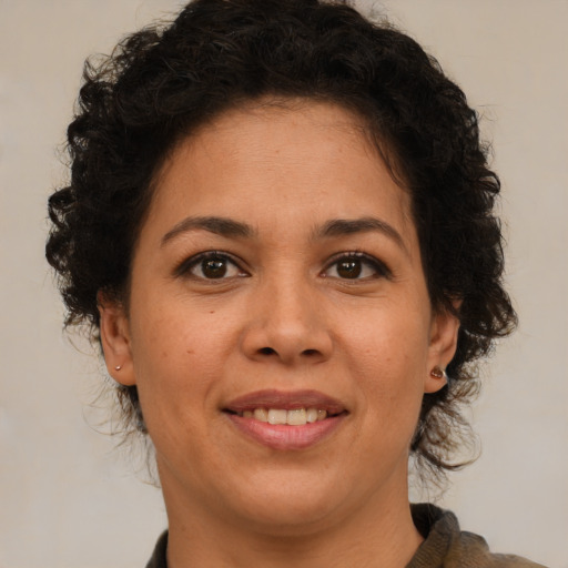 Joyful black adult female with medium  brown hair and brown eyes