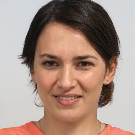 Joyful white young-adult female with medium  brown hair and brown eyes