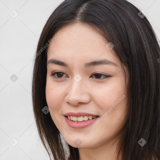 Joyful asian young-adult female with long  brown hair and brown eyes