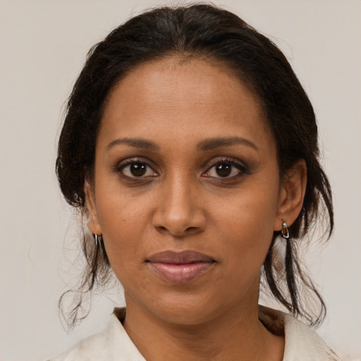 Joyful black young-adult female with medium  brown hair and brown eyes