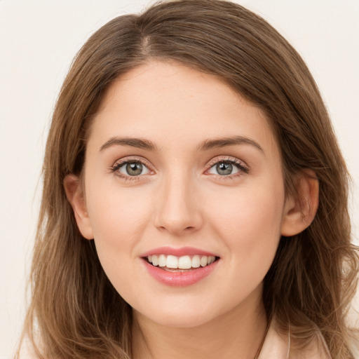 Joyful white young-adult female with long  brown hair and green eyes