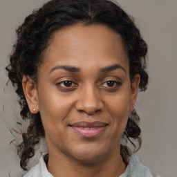 Joyful black adult female with medium  brown hair and brown eyes