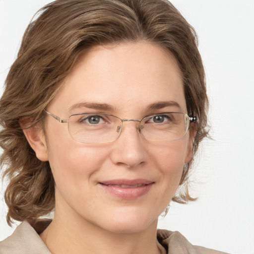 Joyful white adult female with medium  brown hair and grey eyes