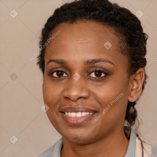 Joyful black young-adult female with short  brown hair and brown eyes