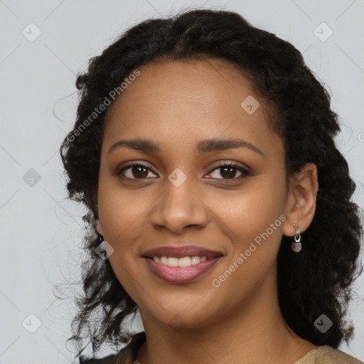 Joyful black young-adult female with long  black hair and brown eyes