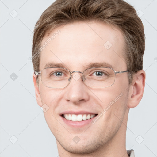 Joyful white adult male with short  brown hair and grey eyes