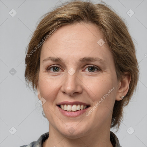 Joyful white adult female with medium  brown hair and grey eyes