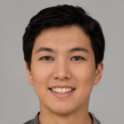 Joyful asian young-adult male with short  black hair and brown eyes