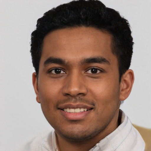 Joyful latino young-adult male with short  black hair and brown eyes