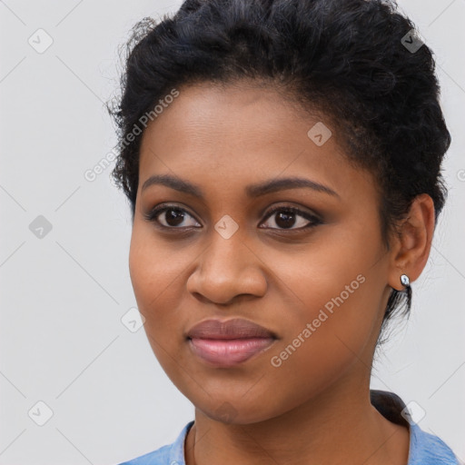 Joyful black young-adult female with long  black hair and brown eyes