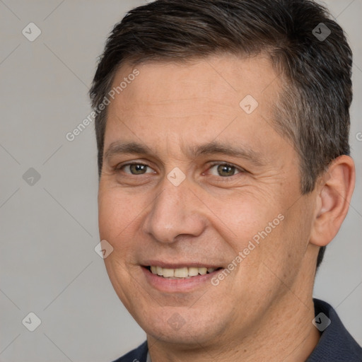 Joyful white adult male with short  brown hair and brown eyes