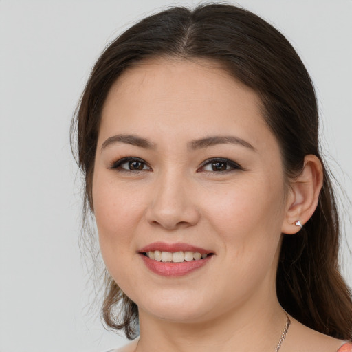 Joyful white young-adult female with long  brown hair and brown eyes