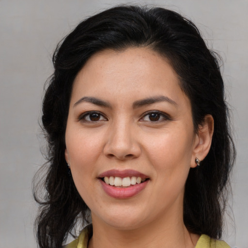 Joyful latino young-adult female with long  brown hair and brown eyes