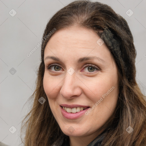 Joyful white young-adult female with long  brown hair and green eyes