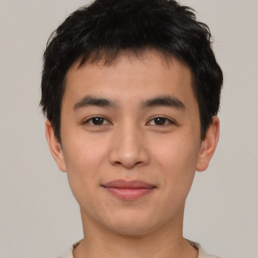 Joyful asian young-adult male with short  brown hair and brown eyes