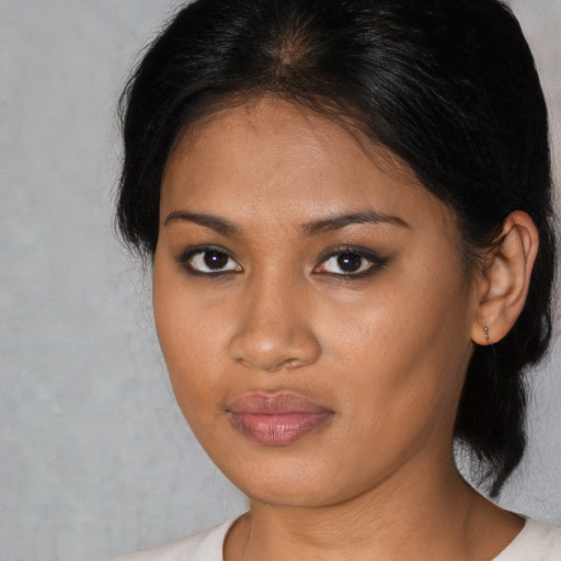 Neutral black young-adult female with medium  brown hair and brown eyes