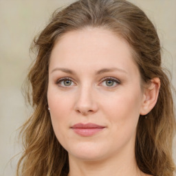 Joyful white young-adult female with long  brown hair and green eyes