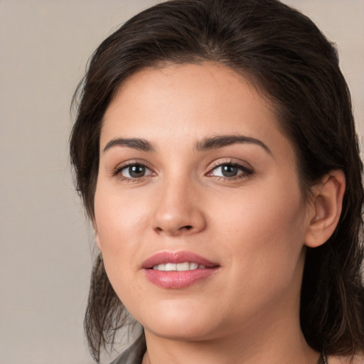 Joyful white young-adult female with medium  brown hair and brown eyes