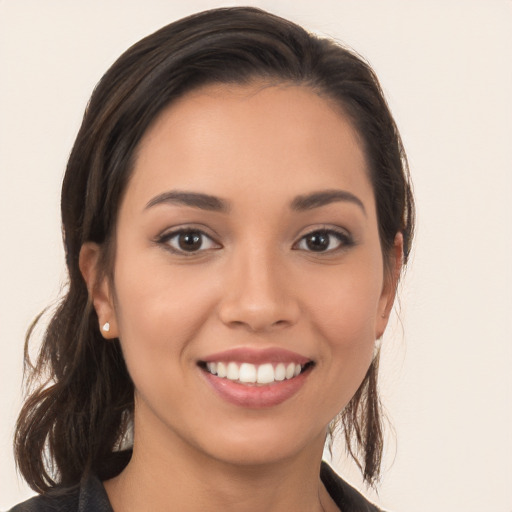 Joyful white young-adult female with long  brown hair and brown eyes